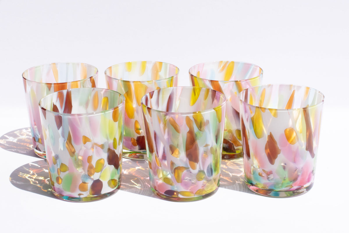 Handblown glass from asheville north carolina made by stephanie mccune. short glasses with colorful rainbow frit blown into them